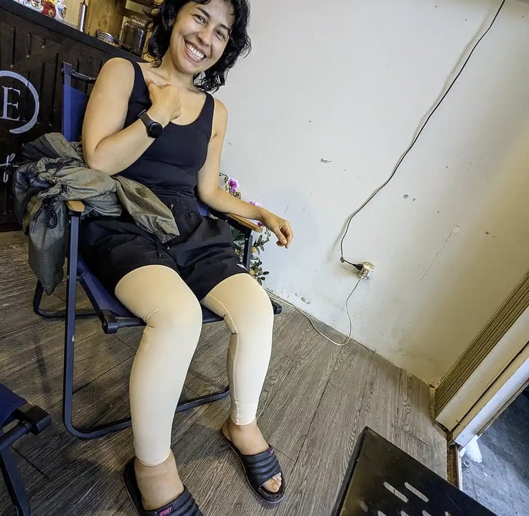 Person recovering after leg surgery sitting and smiling indoors