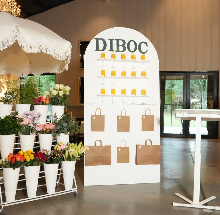 DIBOC floral & chocolate tasting display with fresh flowers and branded setup at luxury Tampa event