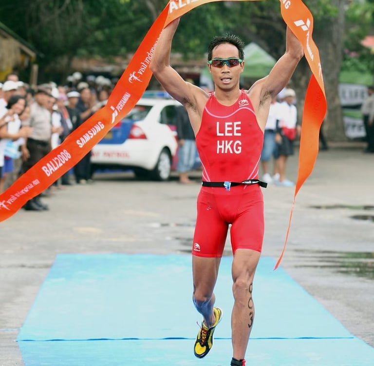 Photo of Daniel Lee, Hong Kong triathlete, crossing the finish line at the Bali 2008 triathlon