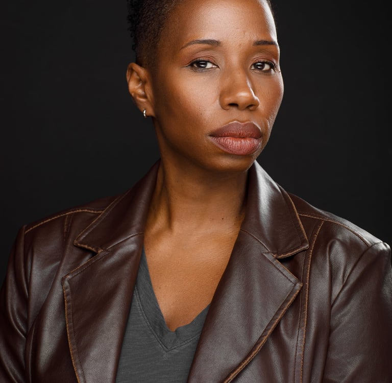 Headshot of Tracie Frank looking serious and slightly suspicious.