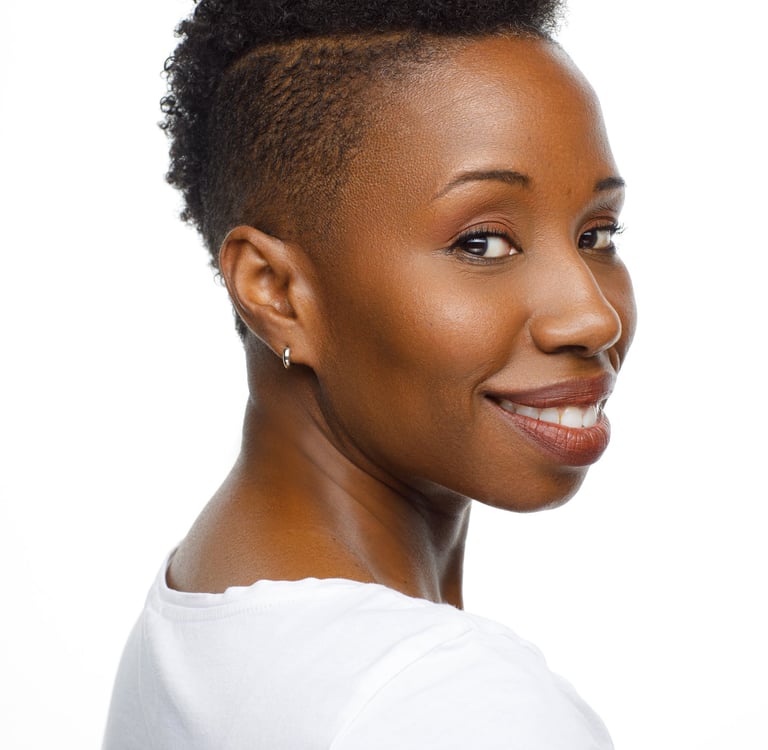 Headshot of Tracie Frank with a sassy over-the-shoulder smile
