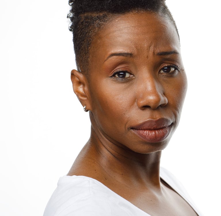 Headshot of Tracie Frank looking over her shoulder with a concerned expression.
