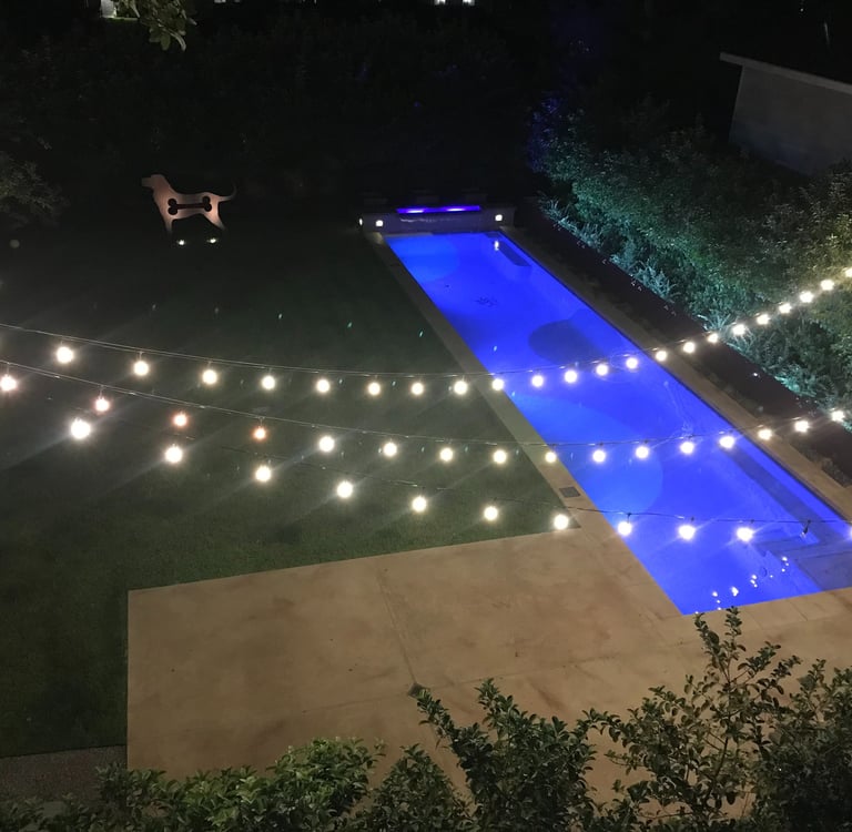 string lighting, strip lighting and accent up lights on statue