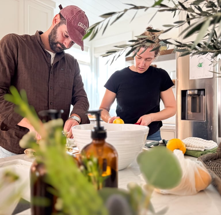 A man and woman preparing traditional Italian food in a home kitchen