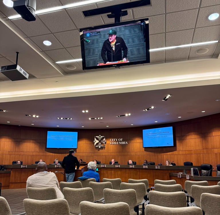 Man standing at the podium before city council.