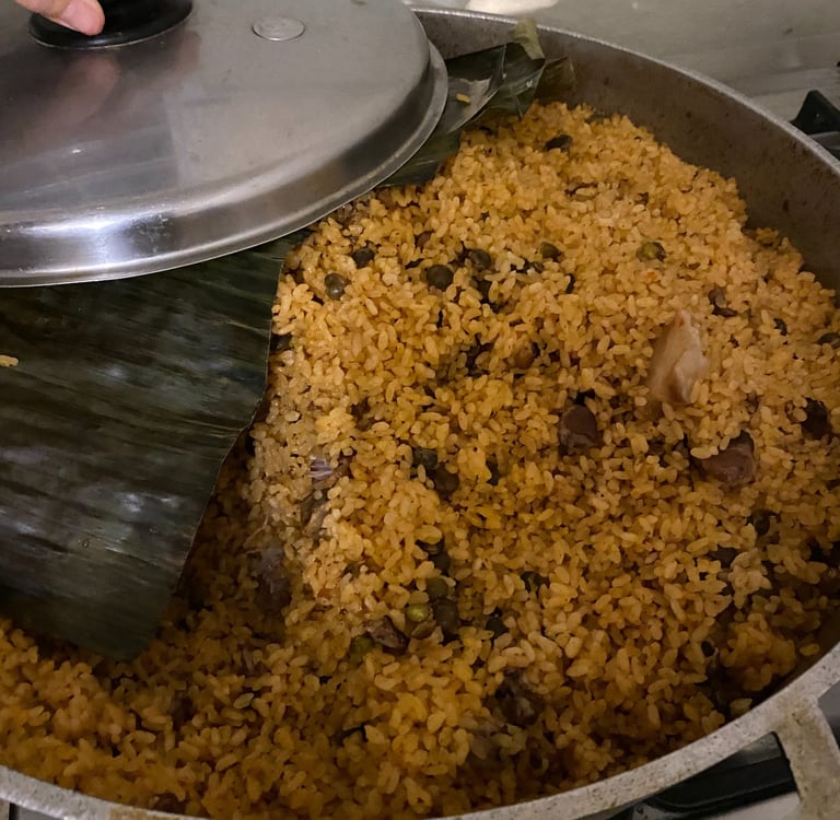 a pot of arroz con gandules with banana leaf
