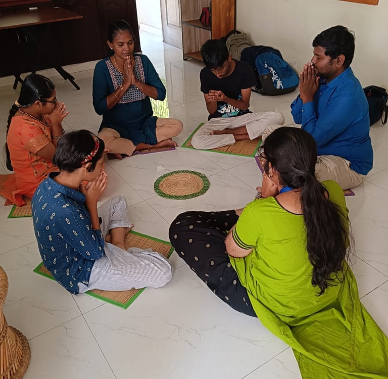 In a respectful and loving environment children are in a circle and doing morning prayer