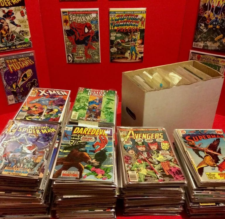 a table with a lot of comics books and comics