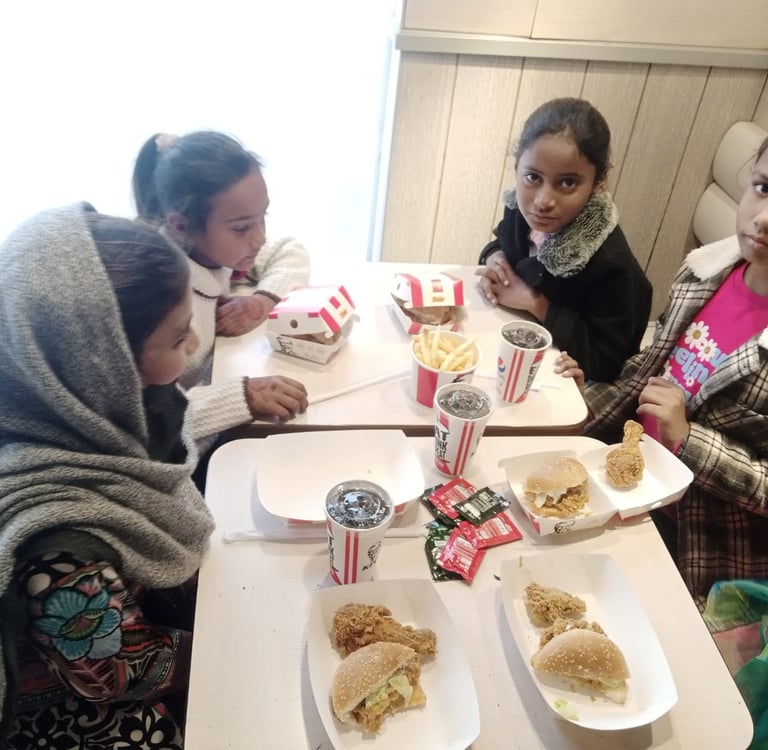 Sunday School children at Water of Life Ministries having lunch burgers and drinks