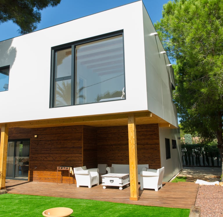 a house with a deck and a deck with chairs