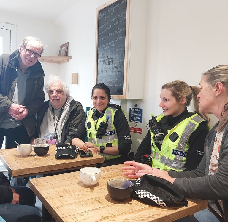 Members of the public with community policing team in coffee shop