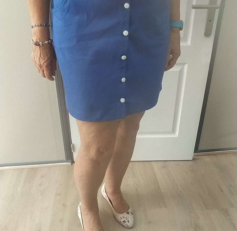 a woman in a floral top and skirt