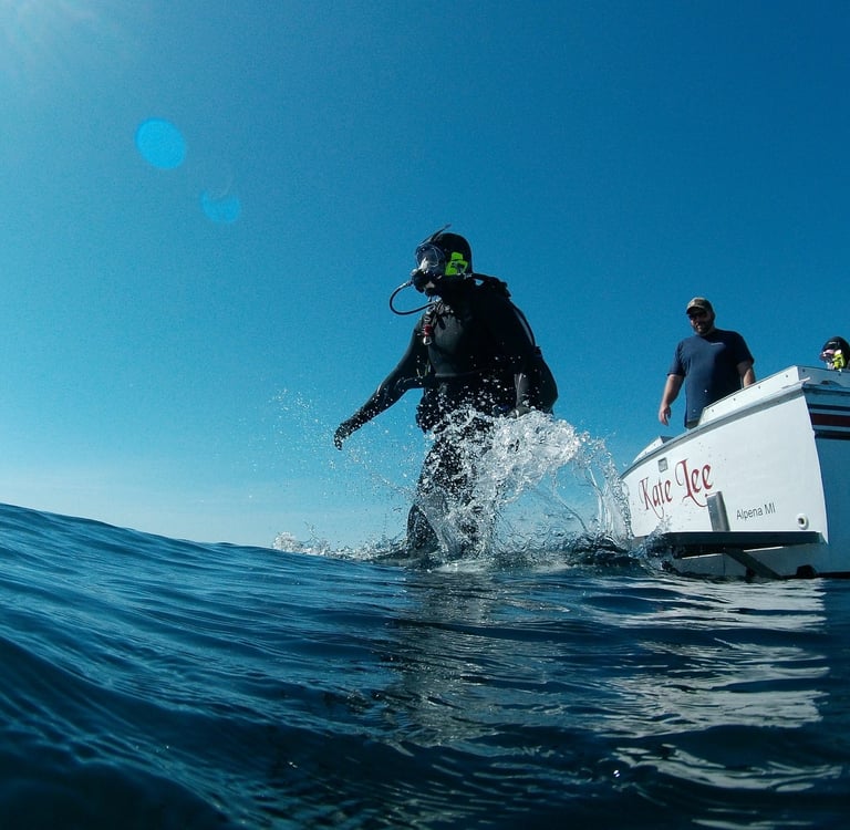 a scuba diver is jumping in the water