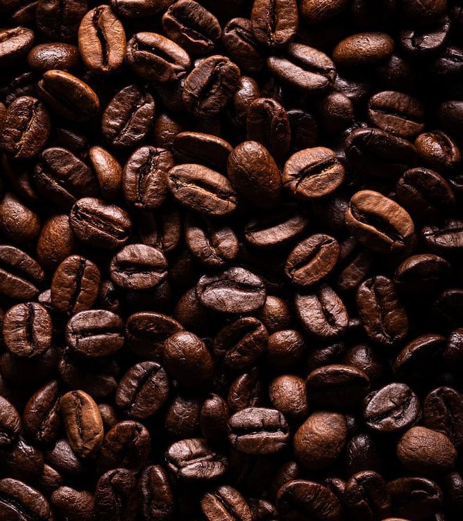 a close up of a pile of coffee beans