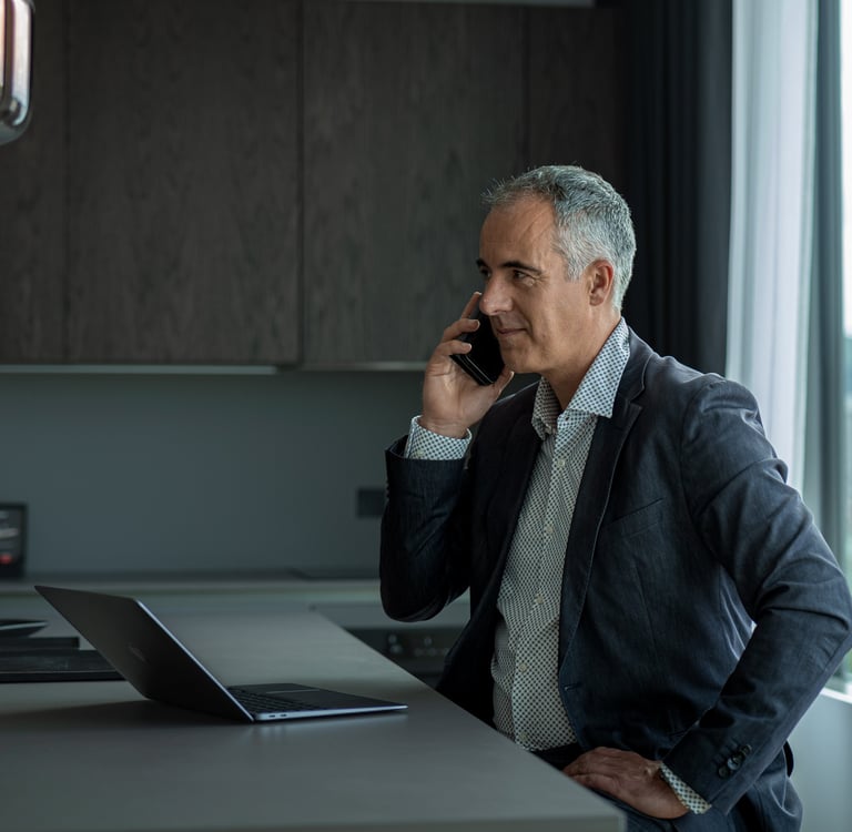 a man in a suit and tie is talking on the phone