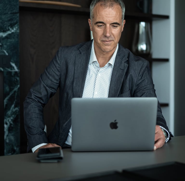 a man in a suit and tie is sitting at a desk