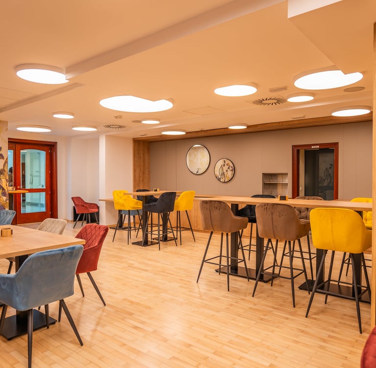 a room with a table and chairs and a clock