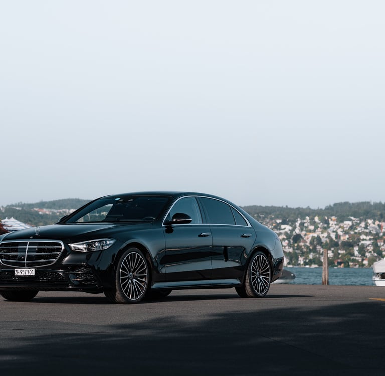 a black mercedes s class on lake zurich