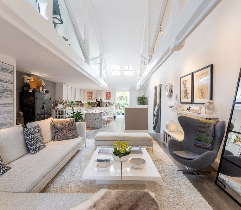 a living room with a couch and a ladder
