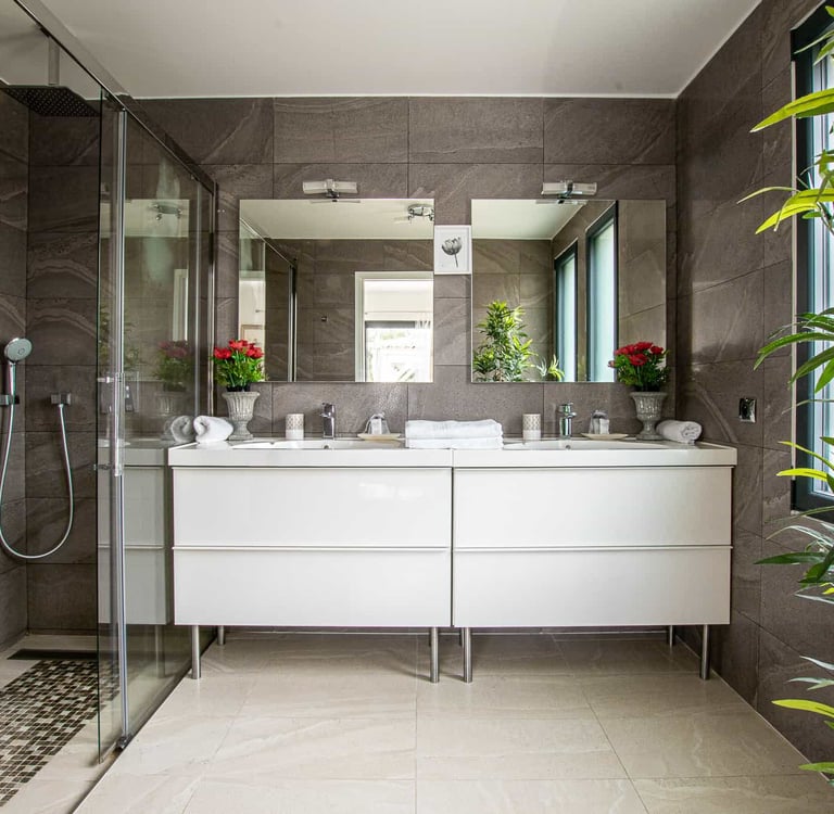 a bathroom with a large mirror and a shower
