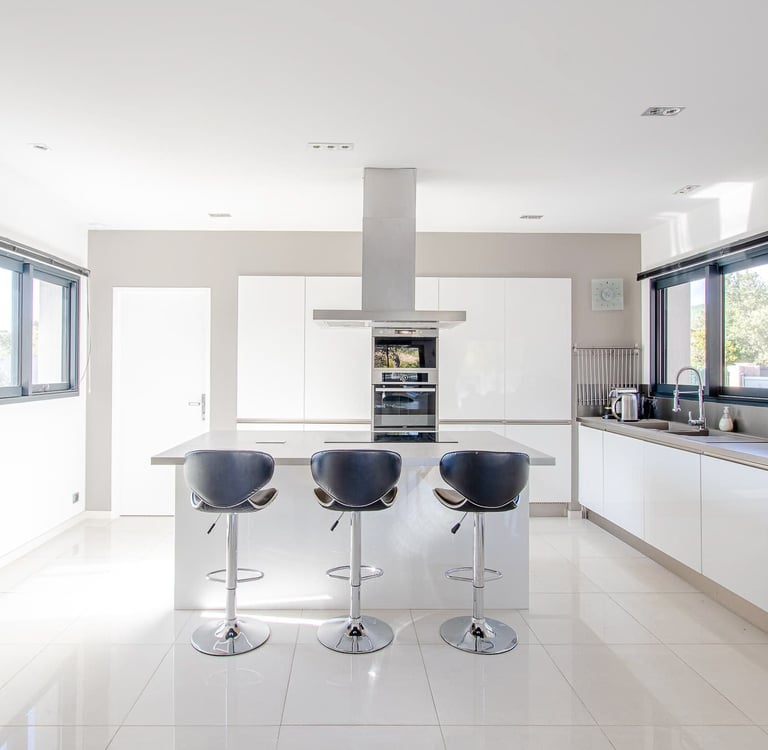 a kitchen with a bar stool and bar stools