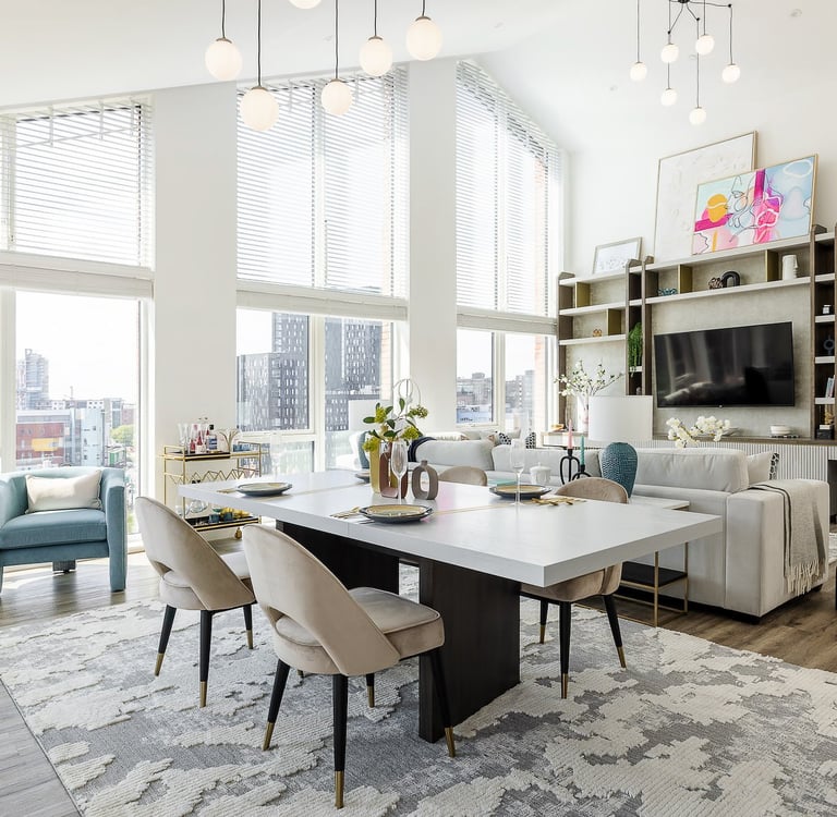 a living room with a large table and chairs