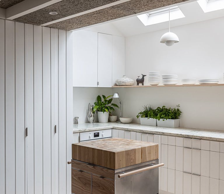a kitchen with a wooden table and a dishwasher