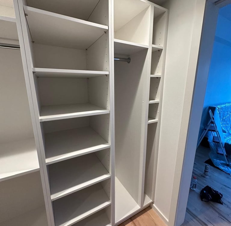 a closet with a closet door open and a closet door open