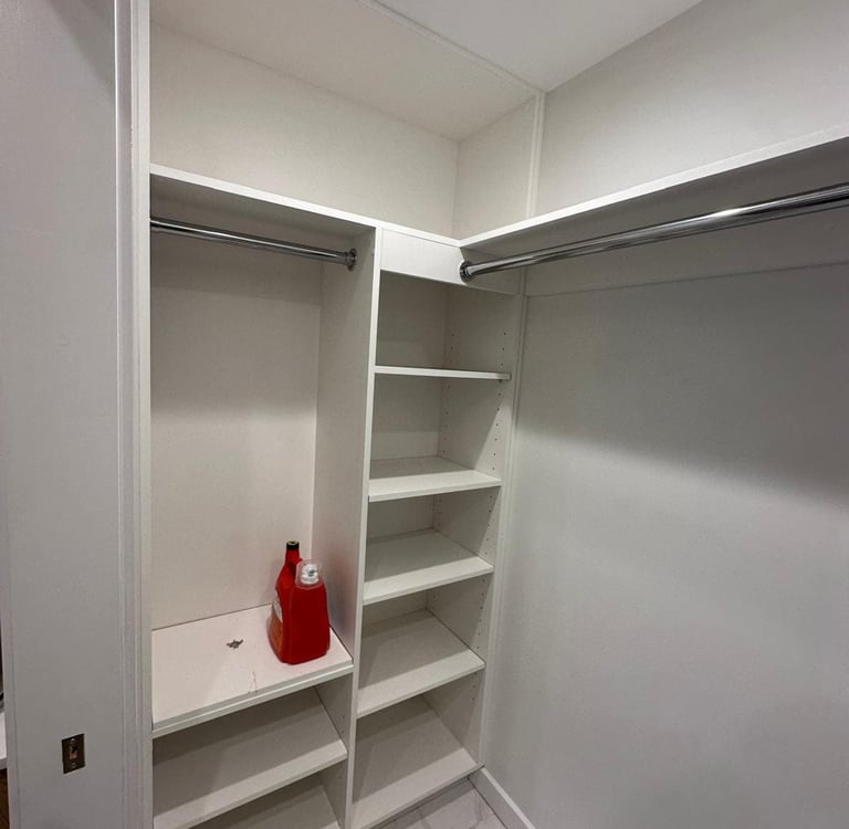 a white closet with shelves and shelves with a red fire hydrant