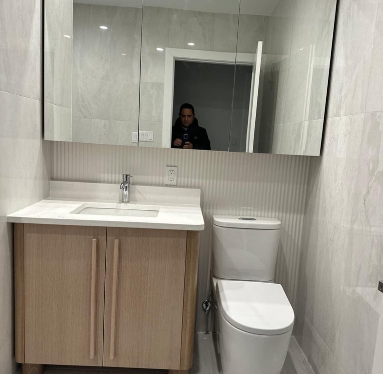 a bathroom with a toilet and a mirror