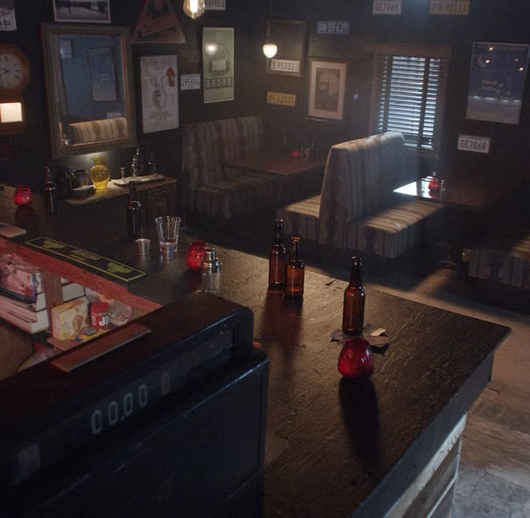 Bar room set at Grayfox Studios with counter, bottles, booths, and vintage wall decor