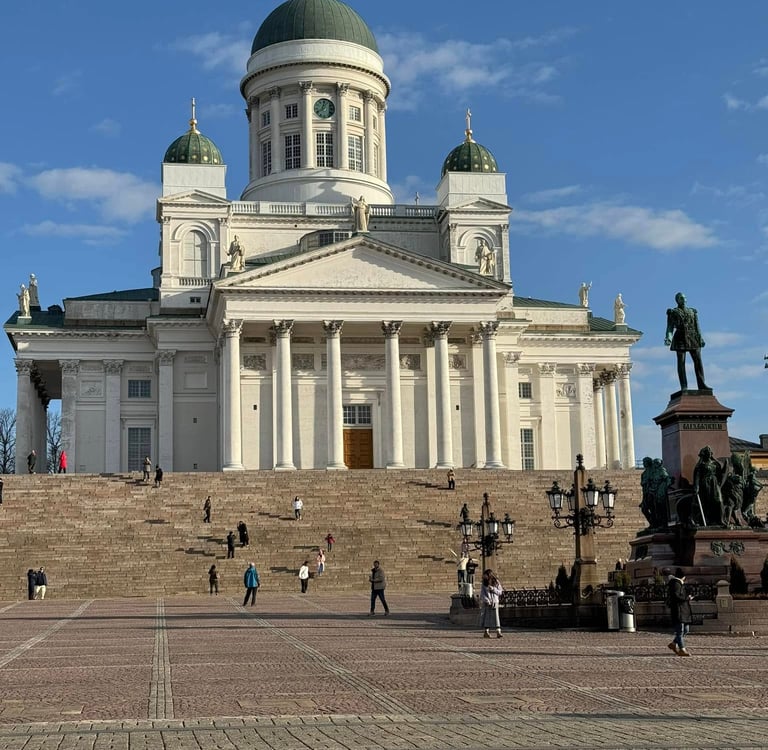 a large white cathedral with green domes