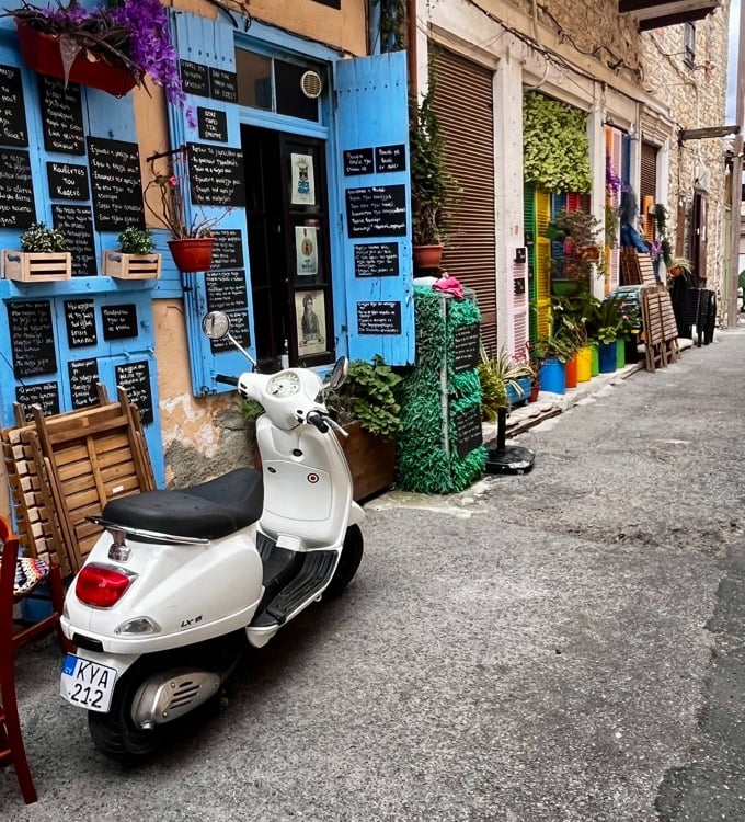 a scooter parked in front of a restaurant