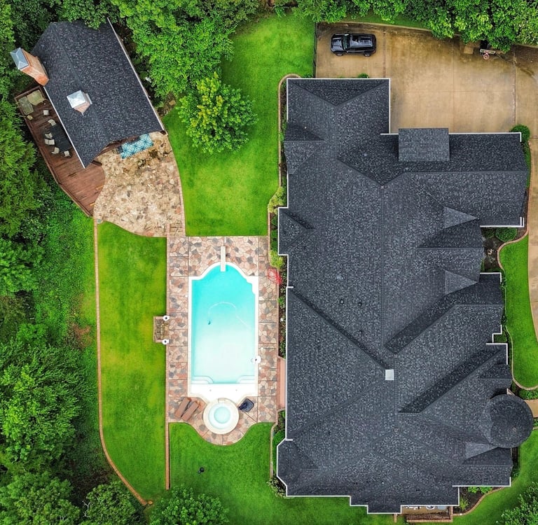 Completed residential roof replacement at a luxury home in Tyler, TX including pool house