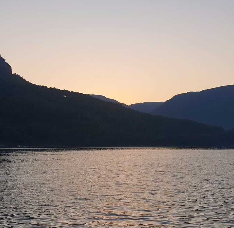 a boat is sailing on the water at sunset