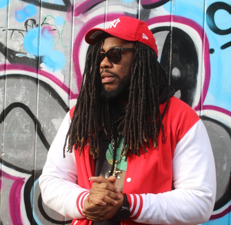 a man with dreadlocks and a red jacket