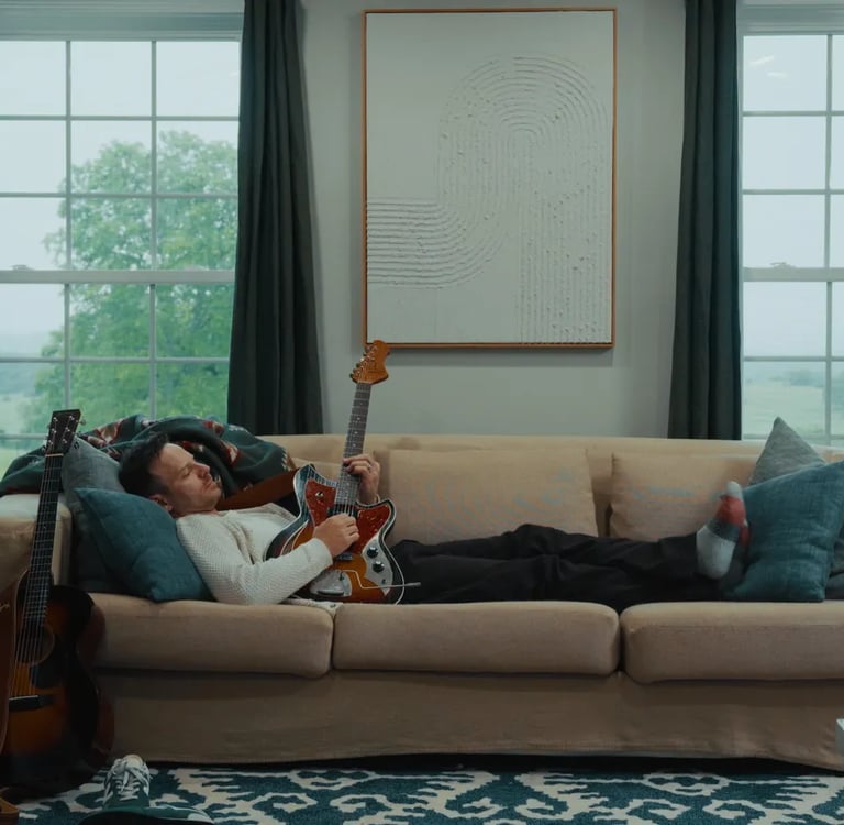 a man laying on a couch in a living room