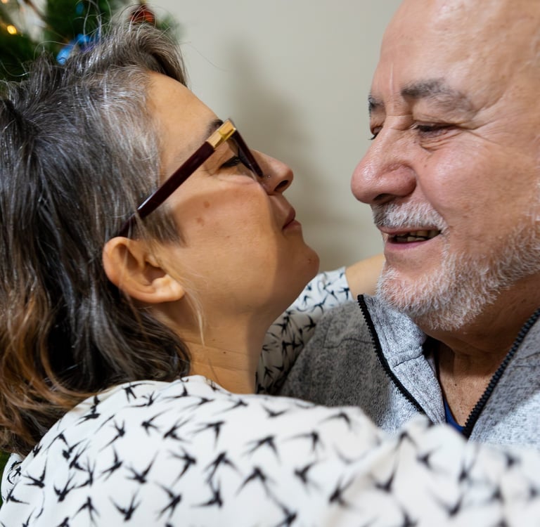 Smiling dad and daughter sharing an affectionate embrace during holiday celebrations at home.