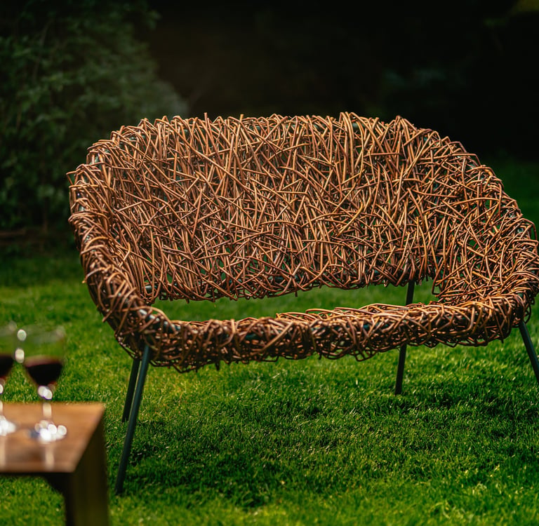 Bespoke 2-seater willow chair with modern green metal frame, handwoven design