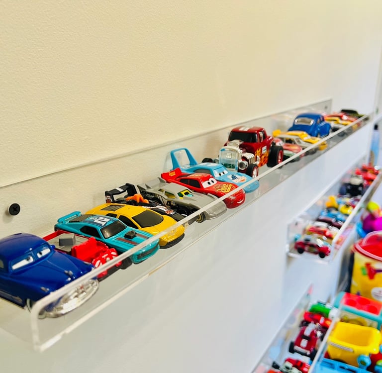 a collection of toy cars on display in a room