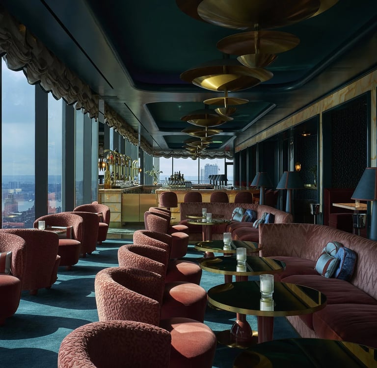 a room with a couch and chairs and a bar Nour Nagy Designs London interior Design