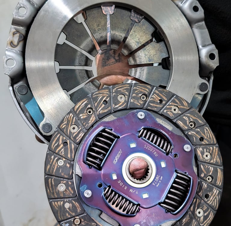 A high-performance Exedy clutch disc and pressure plate assembly for automotive transmission repair.
