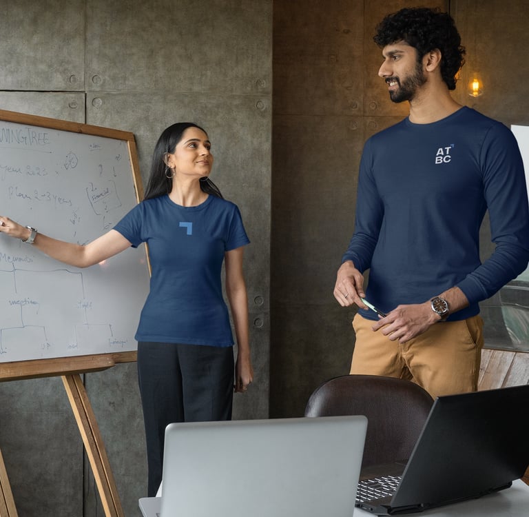 a man and woman standing in front of a white board board