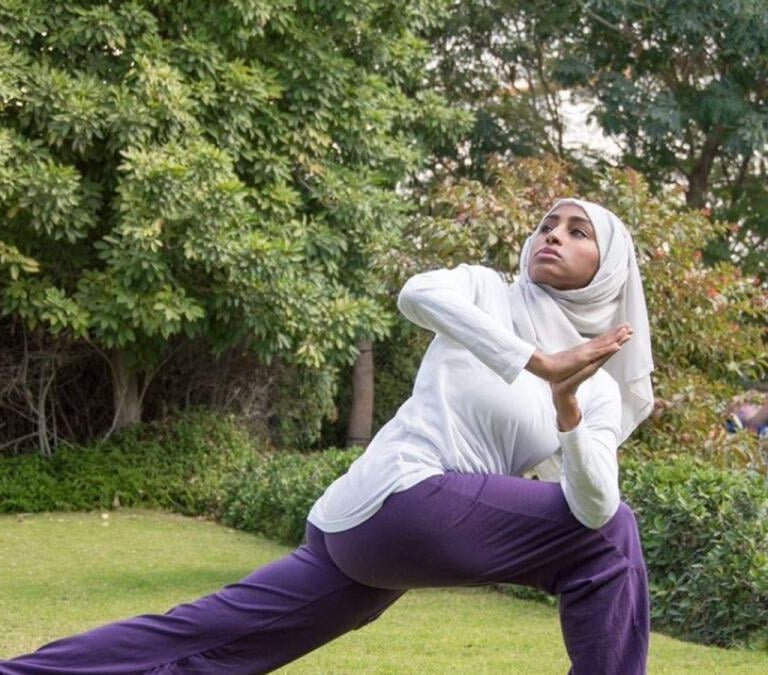 Woman in hijab practicing yoga in dubai