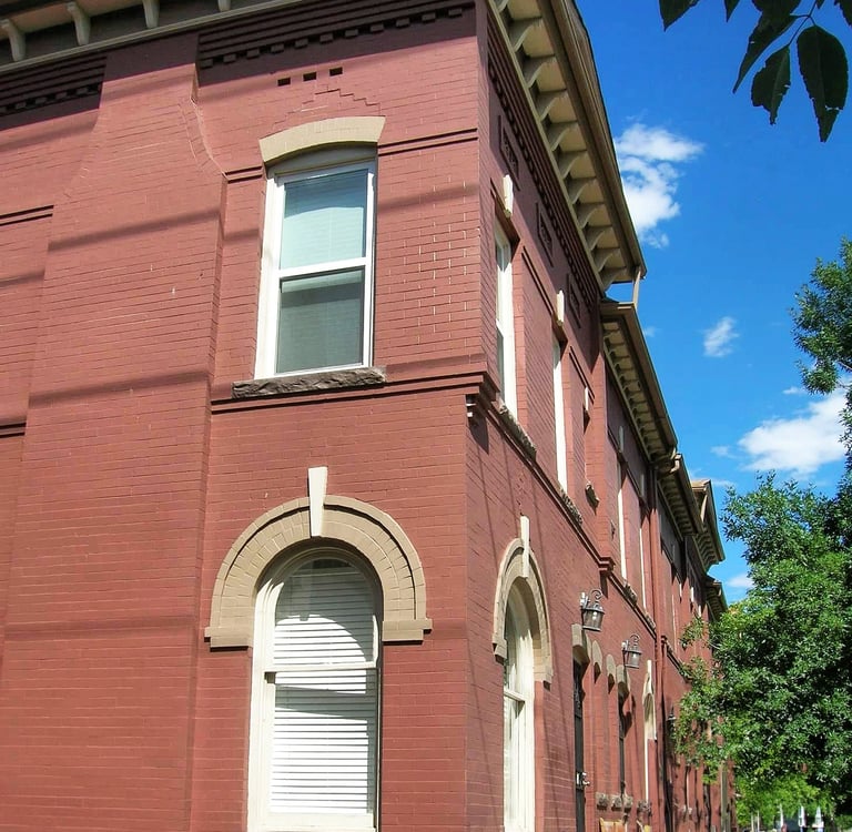 a red brick building with a clock tower in the middle of the street