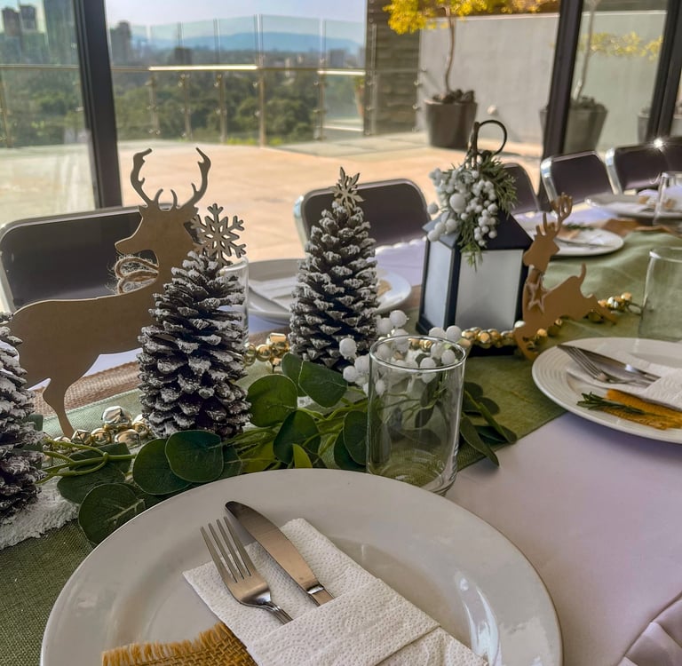 a table setting with pine cones and pine cones
