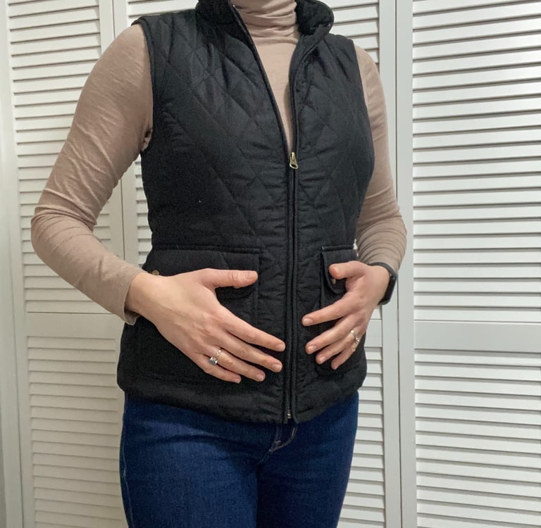 Woman holding stomach addressing hormone issues and fibroids