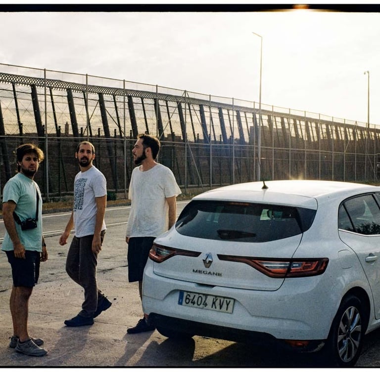 a film crew standing around a car on location