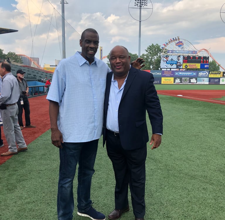 Dominic Carter, author and keynote speaker, with NY Mets legend Dwight Gooden on a baseball field.
