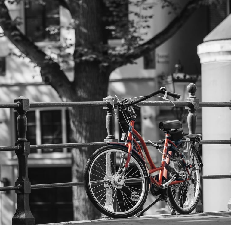 a red bicycle parked on a fence